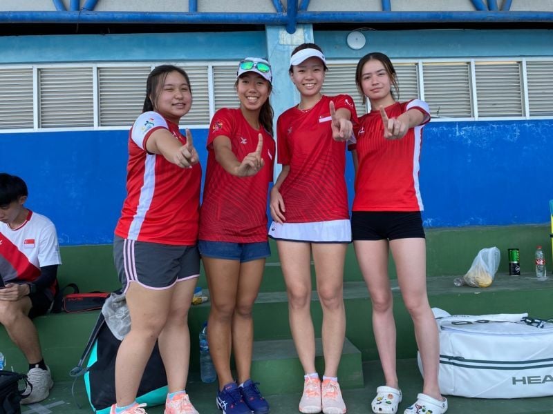 Kay Shan Tammy, Singaporean tennis athlete (two from the right-wearing a hat without glasses) with her teammates before competing at the FIKK UNESA Tennis Court.